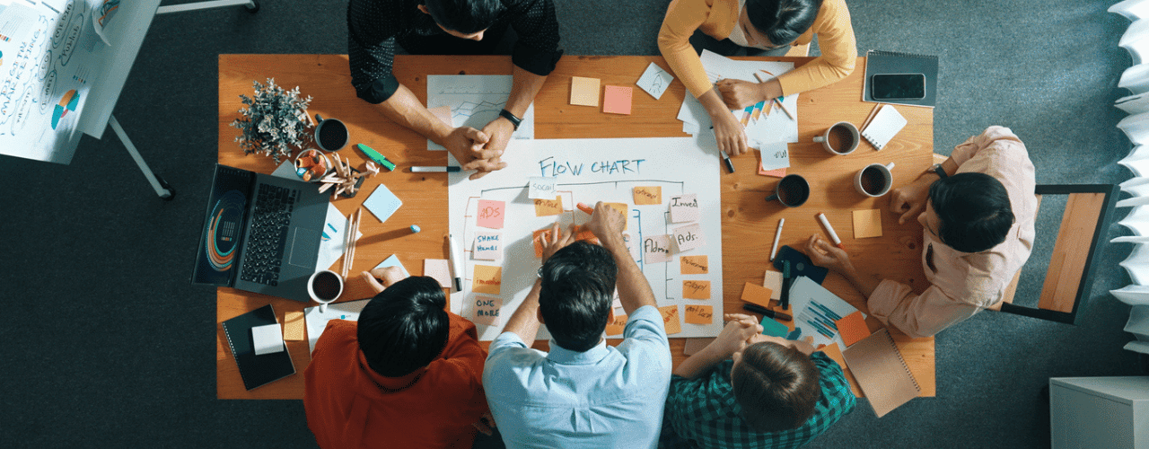 Sales team collaborating on a 90-day sales strategy plan in an office setting